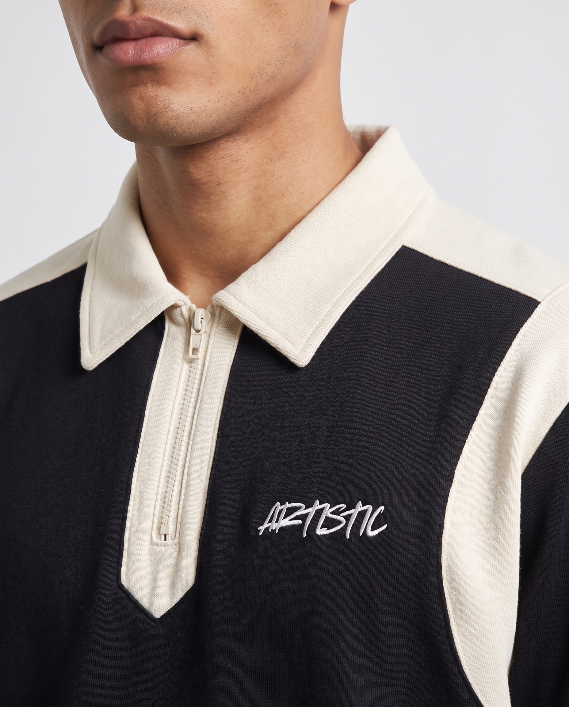 The Night Cap zip polo — collar and logo detail