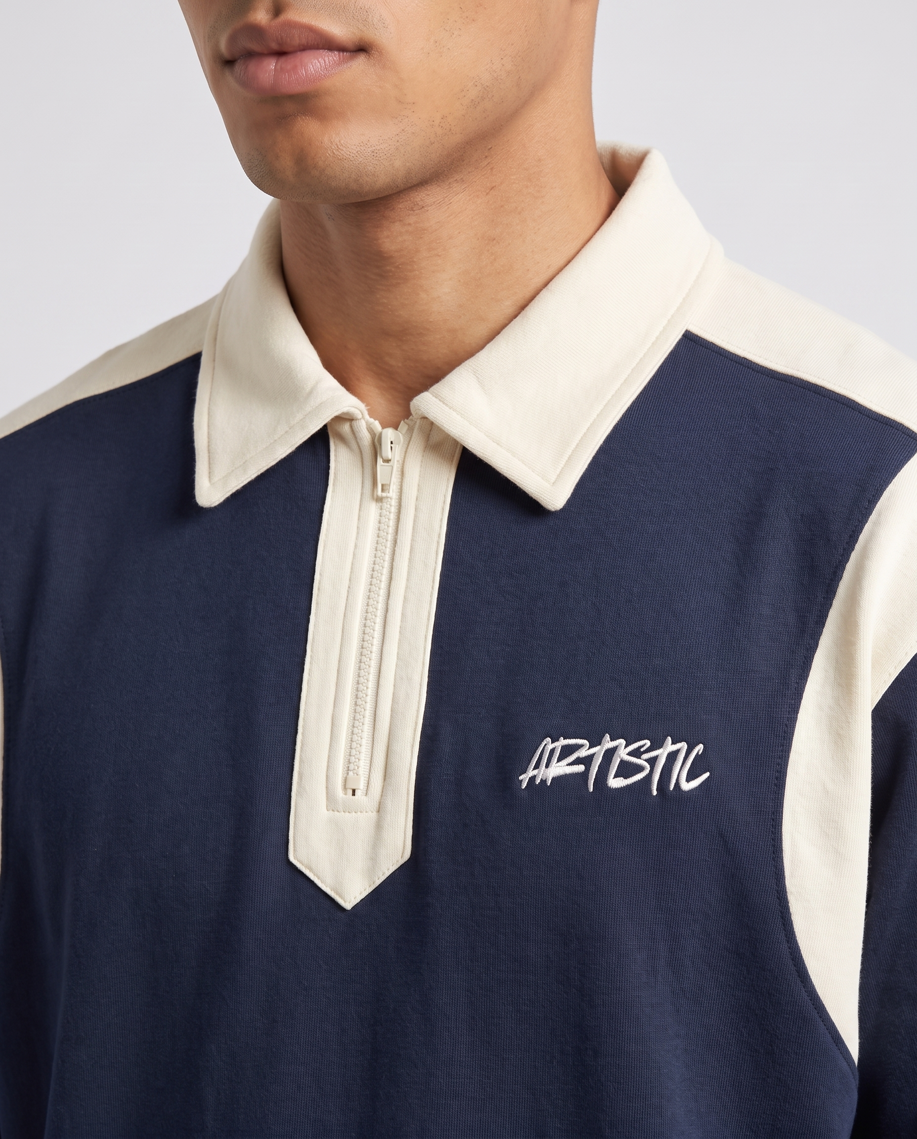 The Deep End zip polo — collar and logo detail