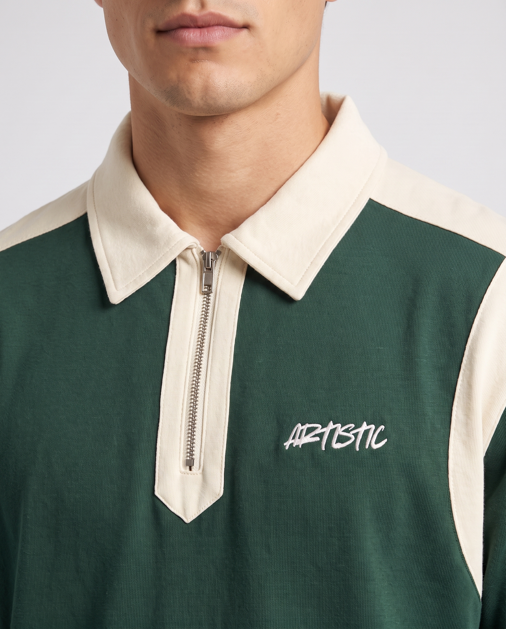The Ink Well zip polo — collar and logo detail