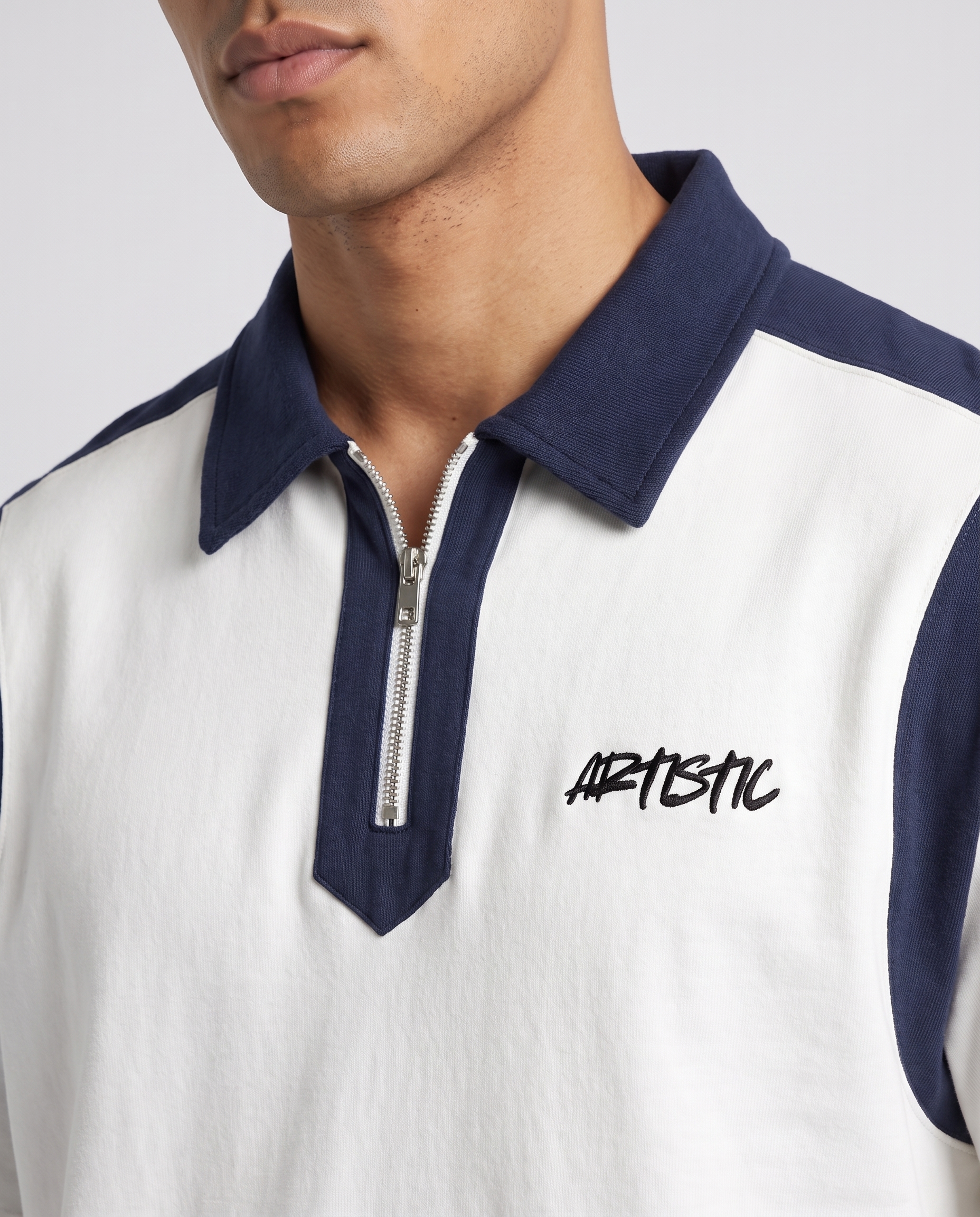 The Coconut Club zip polo — collar and logo detail